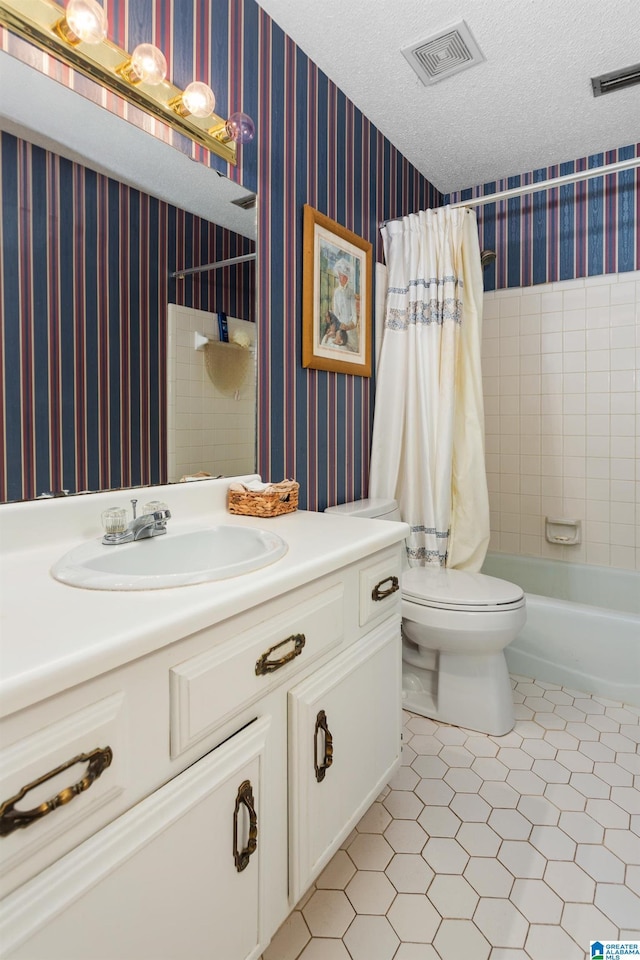 bathroom featuring visible vents, toilet, a textured ceiling, vanity, and wallpapered walls