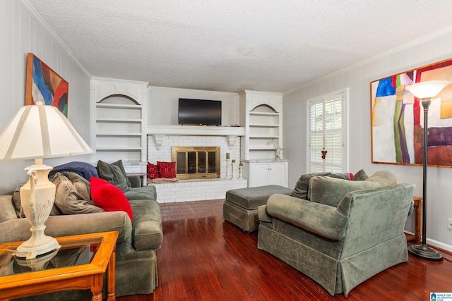 living room with ornamental molding, built in features, hardwood / wood-style flooring, and a textured ceiling