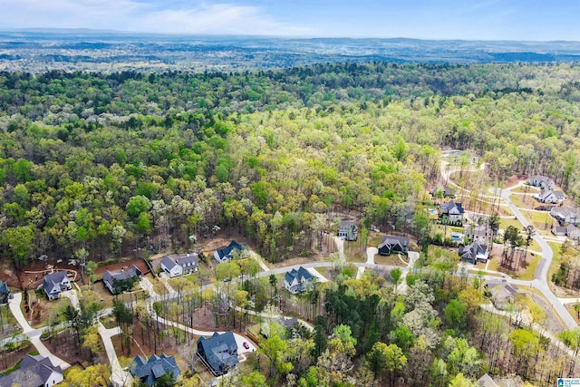 birds eye view of property featuring a residential view and a view of trees