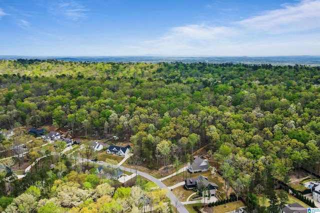 bird's eye view with a wooded view and a residential view