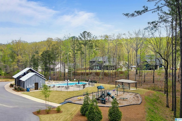 view of home's community with a yard and playground community