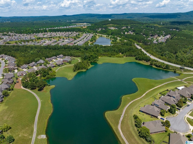 aerial view with a wooded view, a residential view, and a water view
