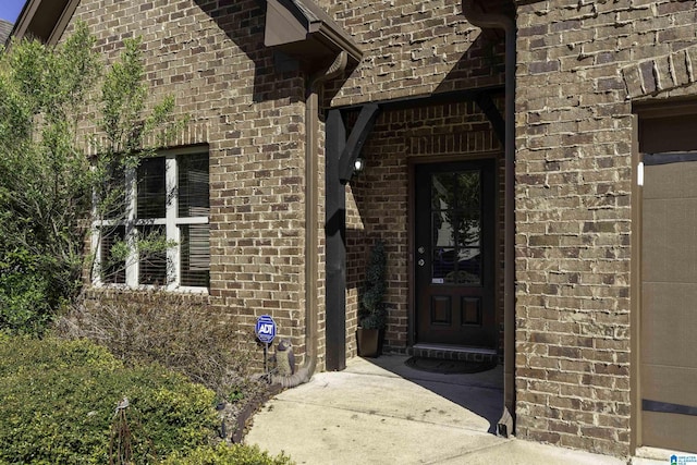property entrance featuring brick siding