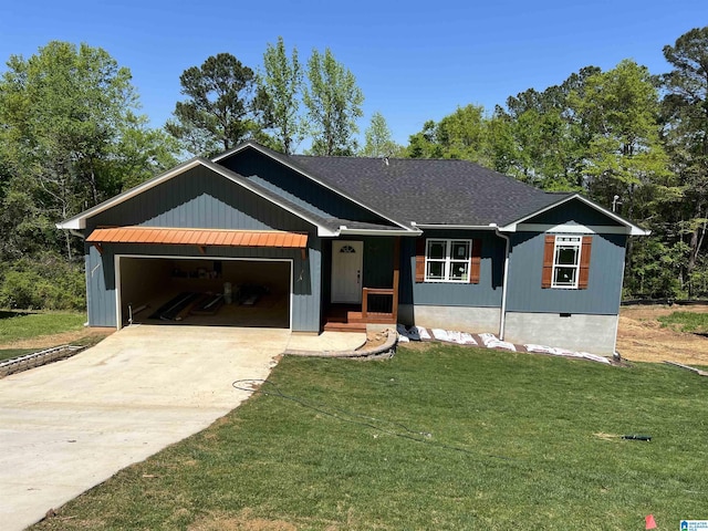 ranch-style home featuring driveway, an attached garage, and a front lawn