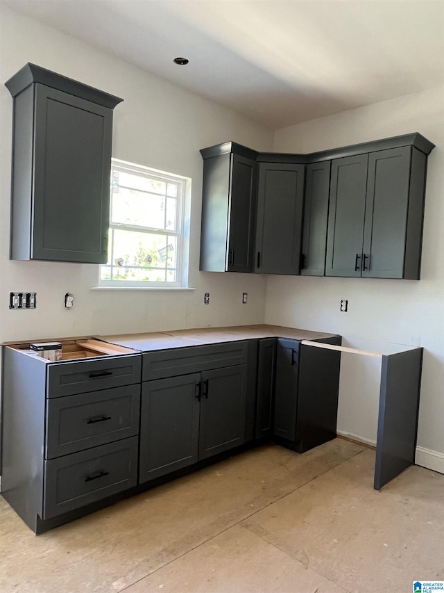 kitchen with gray cabinets and baseboards