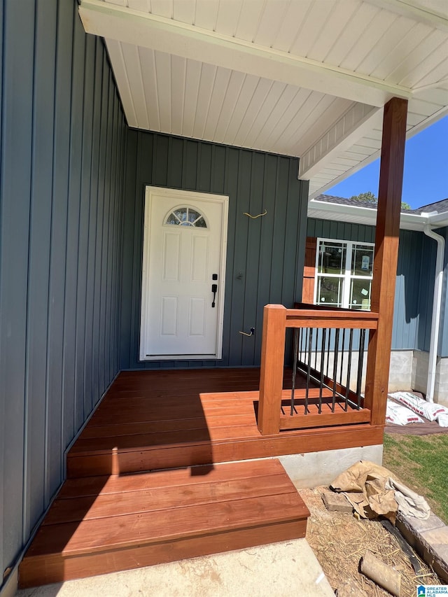 property entrance with board and batten siding and a porch