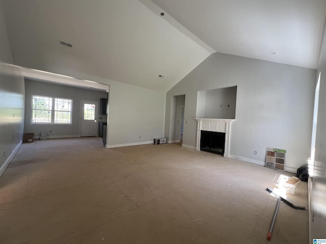unfurnished living room with baseboards, high vaulted ceiling, a fireplace, and visible vents