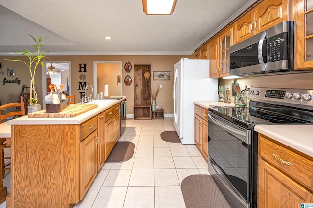 kitchen with stainless steel appliances, a kitchen island with sink, glass insert cabinets, and light countertops