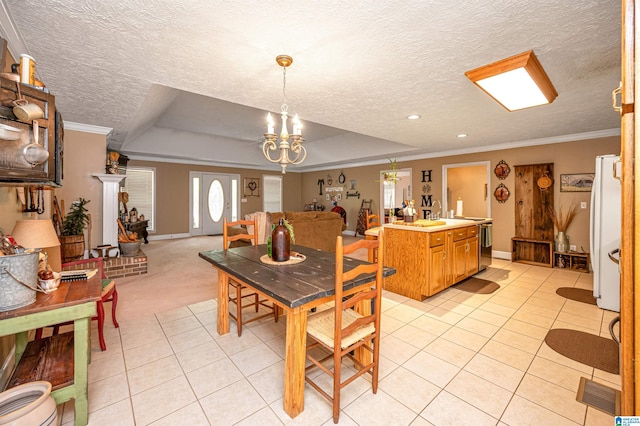 dining area with a chandelier, a textured ceiling, light tile patterned flooring, and ornamental molding