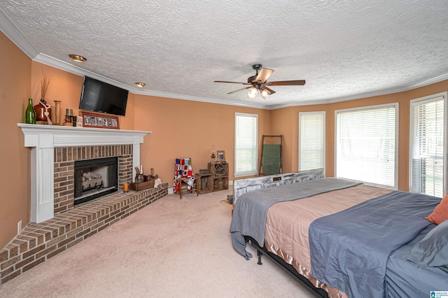 carpeted bedroom with a brick fireplace, a textured ceiling, and crown molding