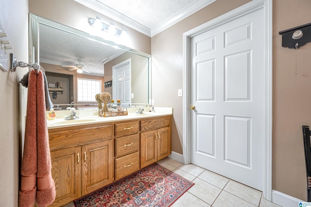 bathroom featuring a sink, ceiling fan, crown molding, and a textured ceiling