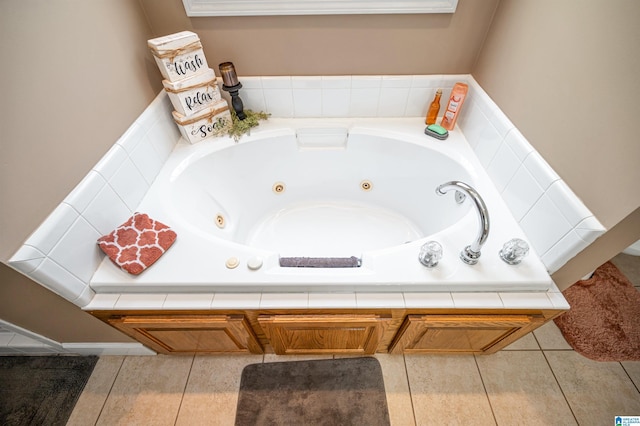 full bath featuring tile patterned floors and a tub with jets
