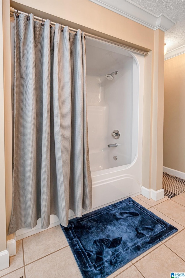 bathroom with crown molding, a textured ceiling, shower / bathtub combination with curtain, tile patterned floors, and baseboards