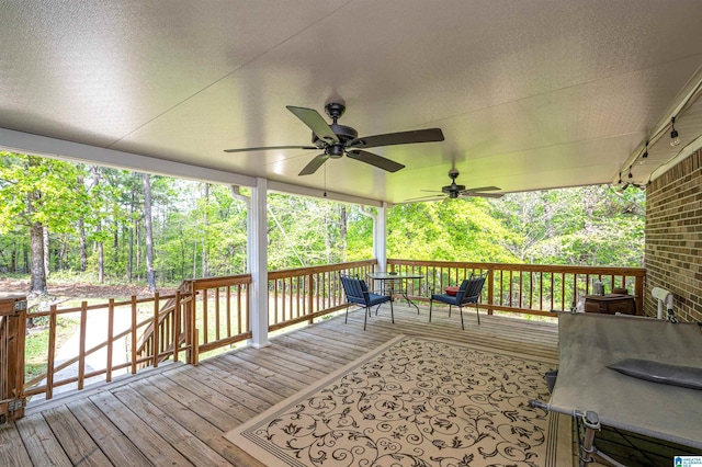 wooden deck with a ceiling fan