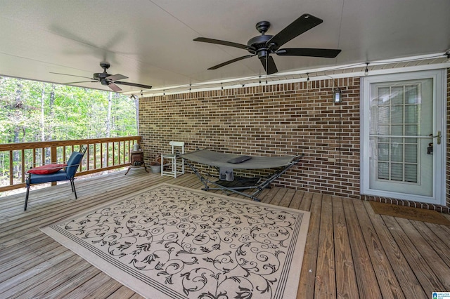 wooden terrace with a ceiling fan