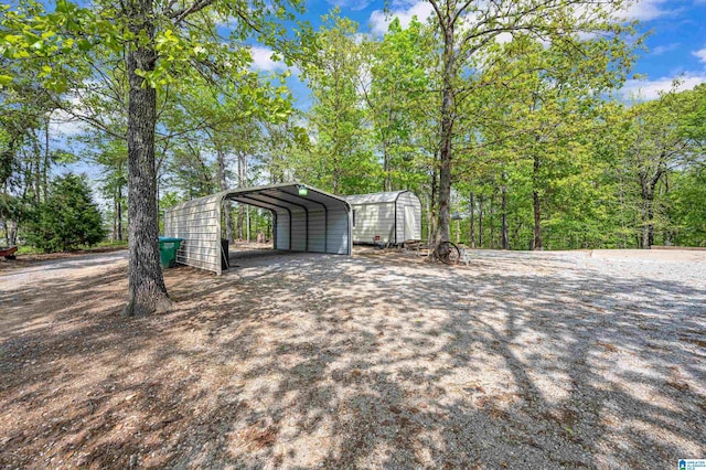 exterior space with a detached carport and driveway