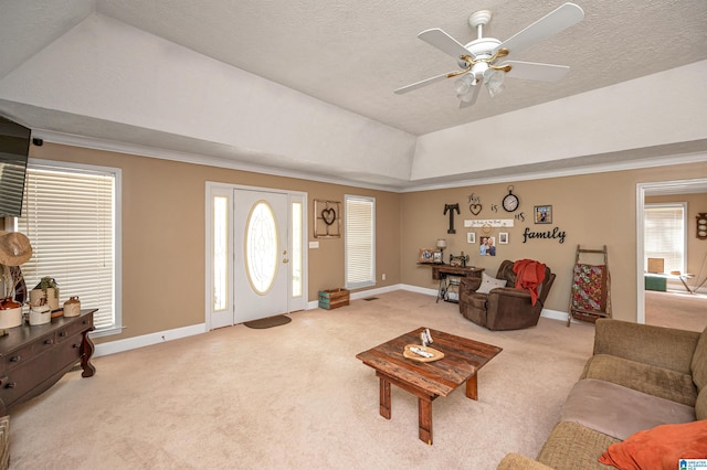 carpeted living area featuring baseboards, a ceiling fan, and a textured ceiling