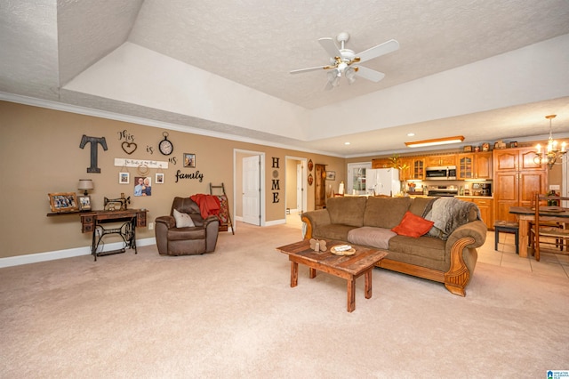 living room featuring ornamental molding, a textured ceiling, a tray ceiling, ceiling fan with notable chandelier, and light colored carpet