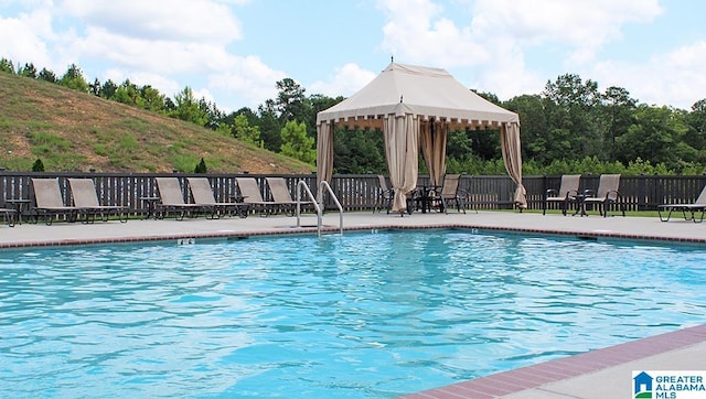 community pool featuring a patio, a gazebo, and fence