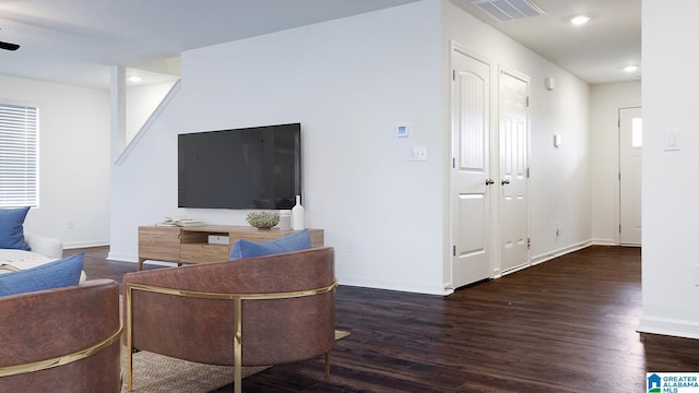 living area with recessed lighting, visible vents, baseboards, and wood finished floors