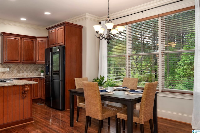 dining space featuring a wealth of natural light, dark wood-style flooring, and an inviting chandelier