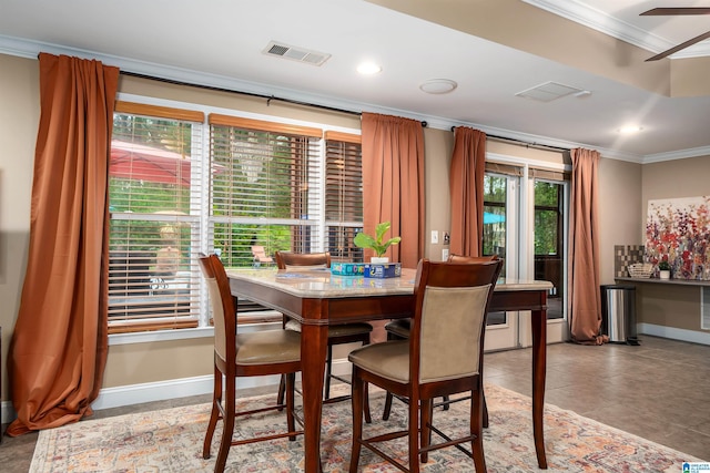 dining space featuring a ceiling fan, baseboards, ornamental molding, and visible vents