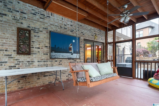 sunroom with french doors, a ceiling fan, and beam ceiling
