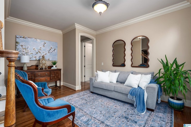 living room featuring crown molding, baseboards, and wood finished floors