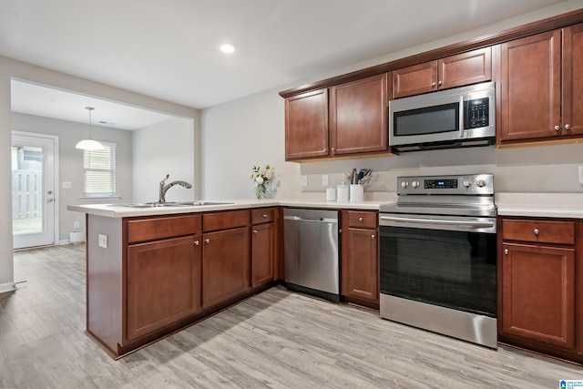6106 Townley Ct, Mccalla, AL 35111 - kitchen featuring a sink, light countertops, appliances with stainless steel finishes, a peninsula, and light wood finished floors