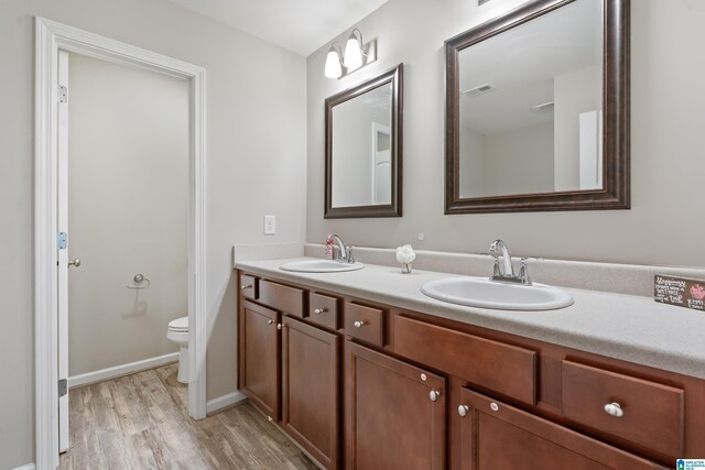 6106 Townley Ct, Mccalla, AL 35111 - bathroom with a sink, visible vents, toilet, and wood finished floors