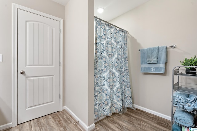 6106 Townley Ct, Mccalla, AL 35111 - full bath with baseboards, curtained shower, and wood finished floors