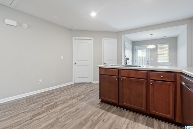 6106 Townley Ct, Mccalla, AL 35111 - kitchen with light wood-style flooring, dishwasher, light countertops, a sink, and baseboards