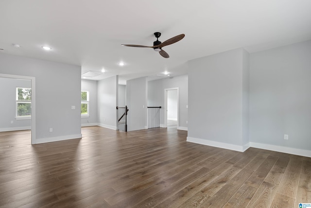 unfurnished living room with dark wood-type flooring, baseboards, recessed lighting, and ceiling fan
