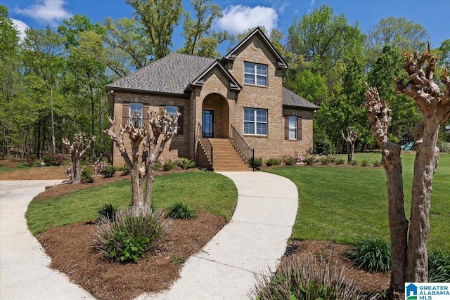 88 Glen Trce, Springville, AL 35146 - view of front of home with a shingled roof, a front yard, and brick siding