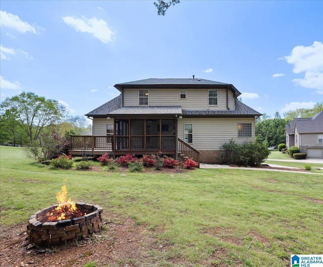 88 Glen Trce, Springville, AL 35146 - back of house featuring a lawn, roof with shingles, a sunroom, and an outdoor fire pit