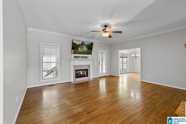 88 Glen Trce, Springville, AL 35146 - unfurnished living room with ornamental molding, a fireplace with flush hearth, wood finished floors, and ceiling fan with notable chandelier