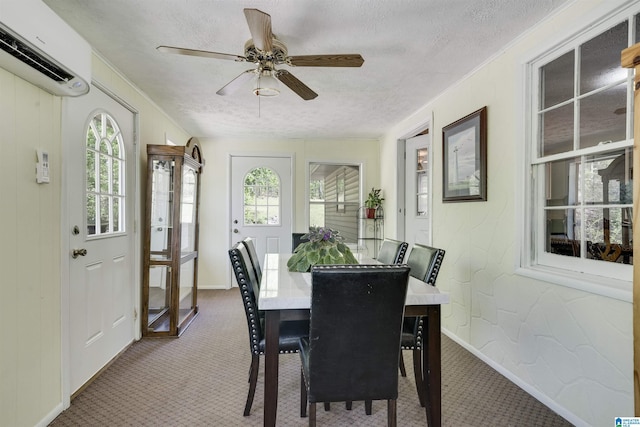 dining space with crown molding, ceiling fan, a textured ceiling, a wall unit AC, and carpet flooring