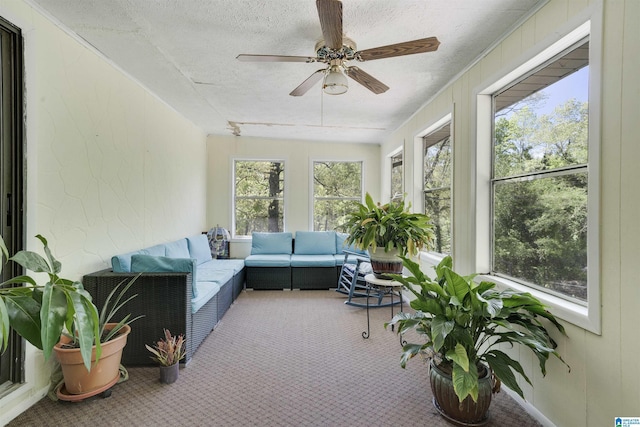 sunroom / solarium featuring carpet and a textured ceiling