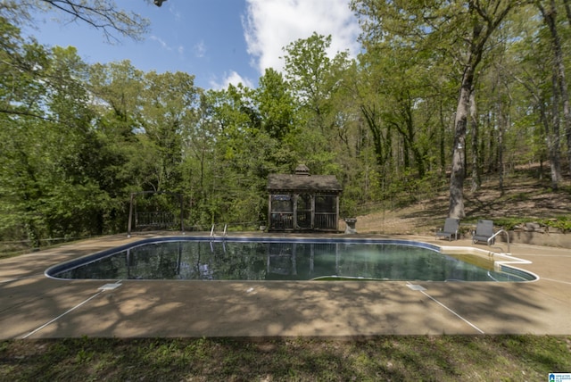 pool featuring a patio, a gazebo, and fence