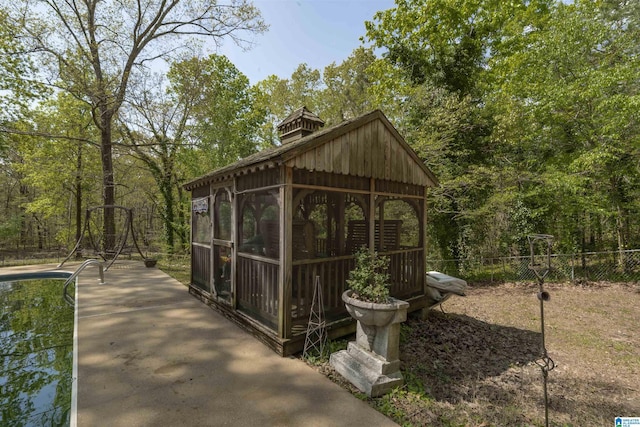 view of outbuilding featuring fence