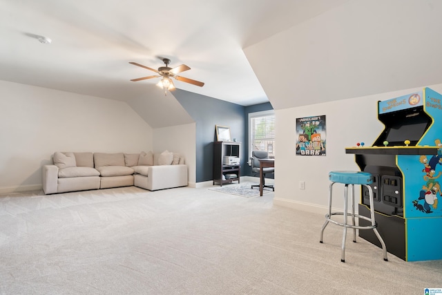 living room featuring carpet flooring, vaulted ceiling, baseboards, and a ceiling fan