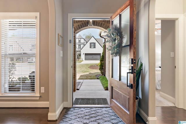 entryway with baseboards and wood finished floors