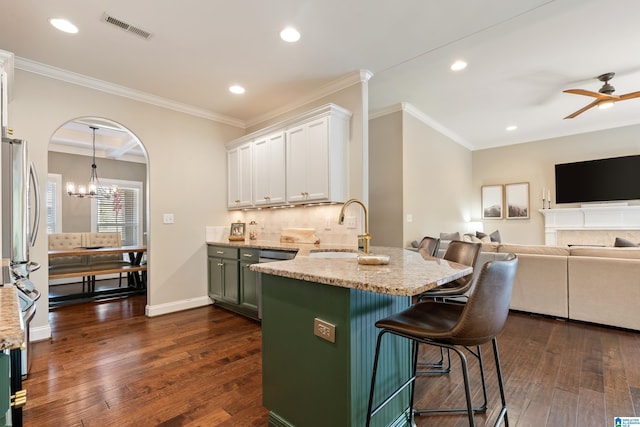kitchen with a sink, visible vents, white cabinetry, and dark wood finished floors