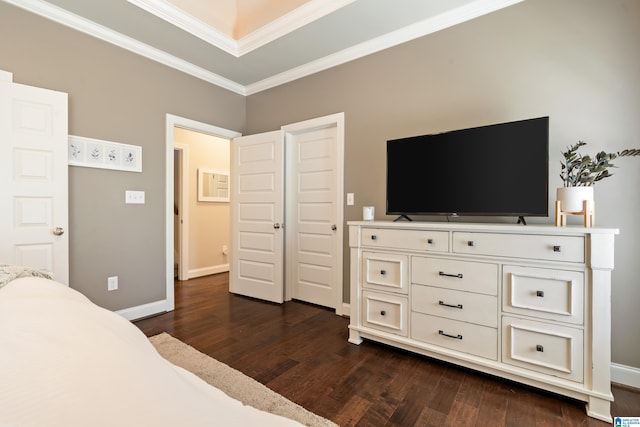 bedroom with dark wood-style floors, baseboards, and ornamental molding