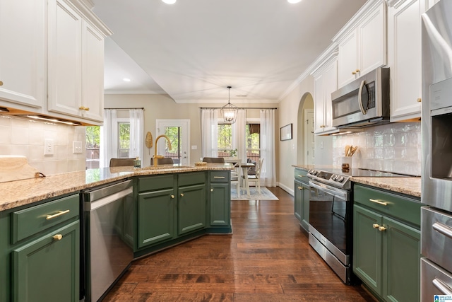 kitchen with a wealth of natural light, white cabinets, appliances with stainless steel finishes, green cabinetry, and a sink