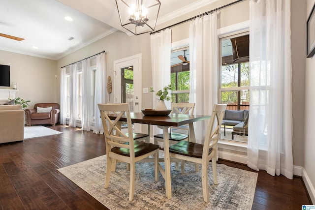 dining area with dark wood-style flooring, baseboards, ornamental molding, recessed lighting, and ceiling fan with notable chandelier