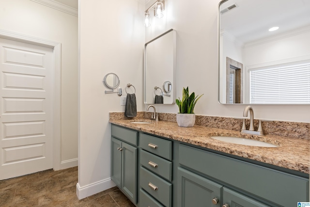 bathroom with a sink, ornamental molding, and visible vents