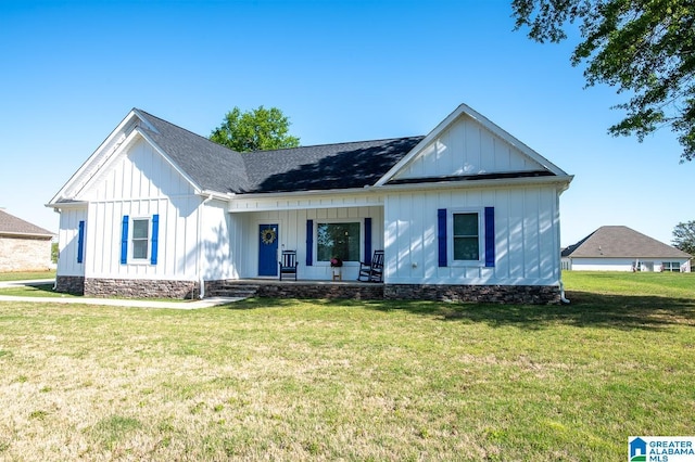 modern farmhouse with covered porch, board and batten siding, a front yard, and a shingled roof