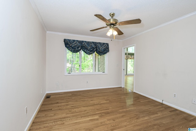 5000 Cameron Rd, Birmingham, AL 35242 - spare room featuring visible vents, baseboards, wood finished floors, ceiling fan, and crown molding