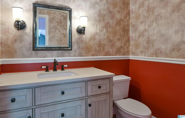5000 Cameron Rd, Birmingham, AL 35242 - half bathroom with toilet, vanity, wallpapered walls, and baseboards